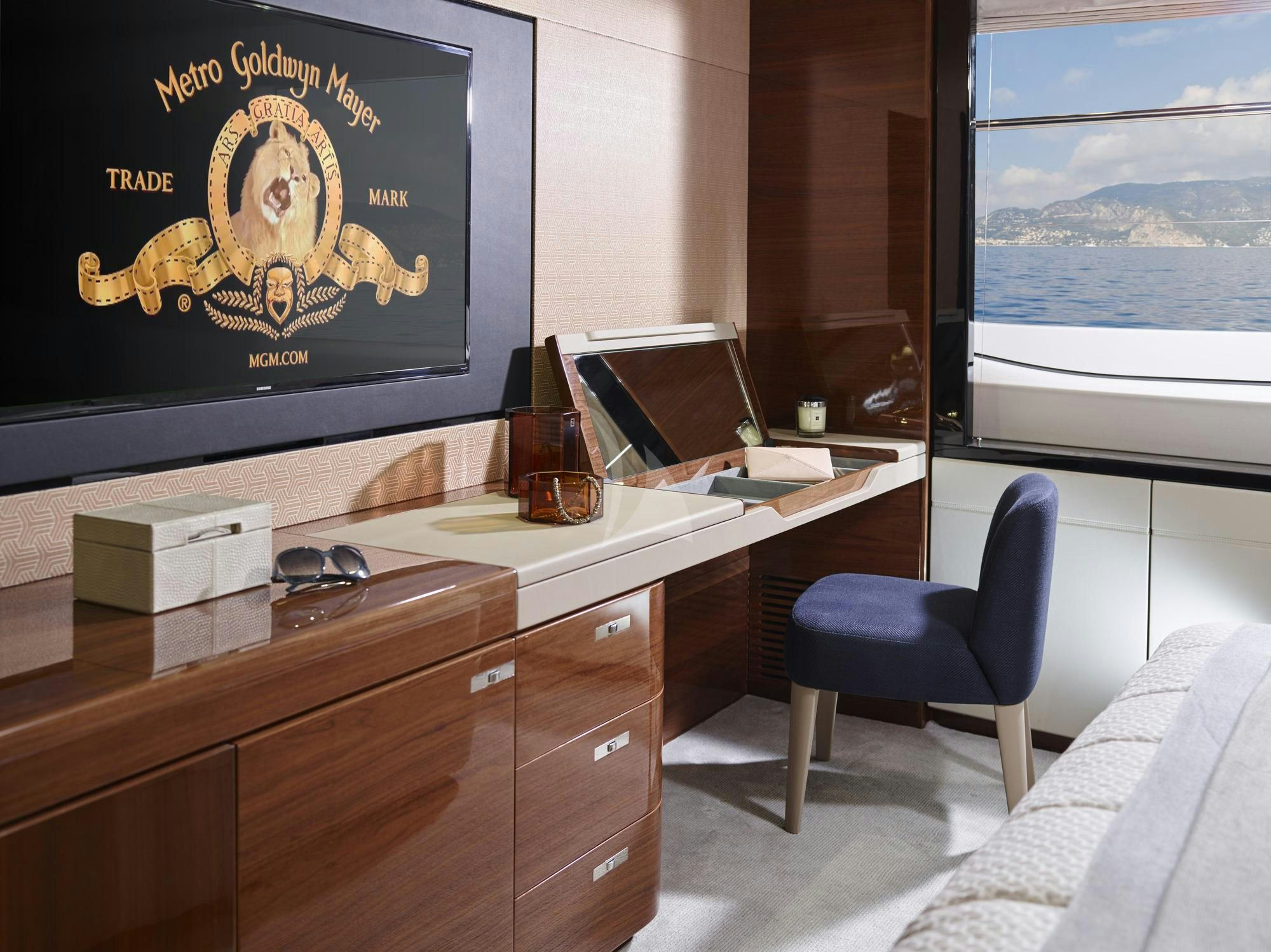 a room with a desk and a tv on the wall aboard KOHUBA Yacht for Charter