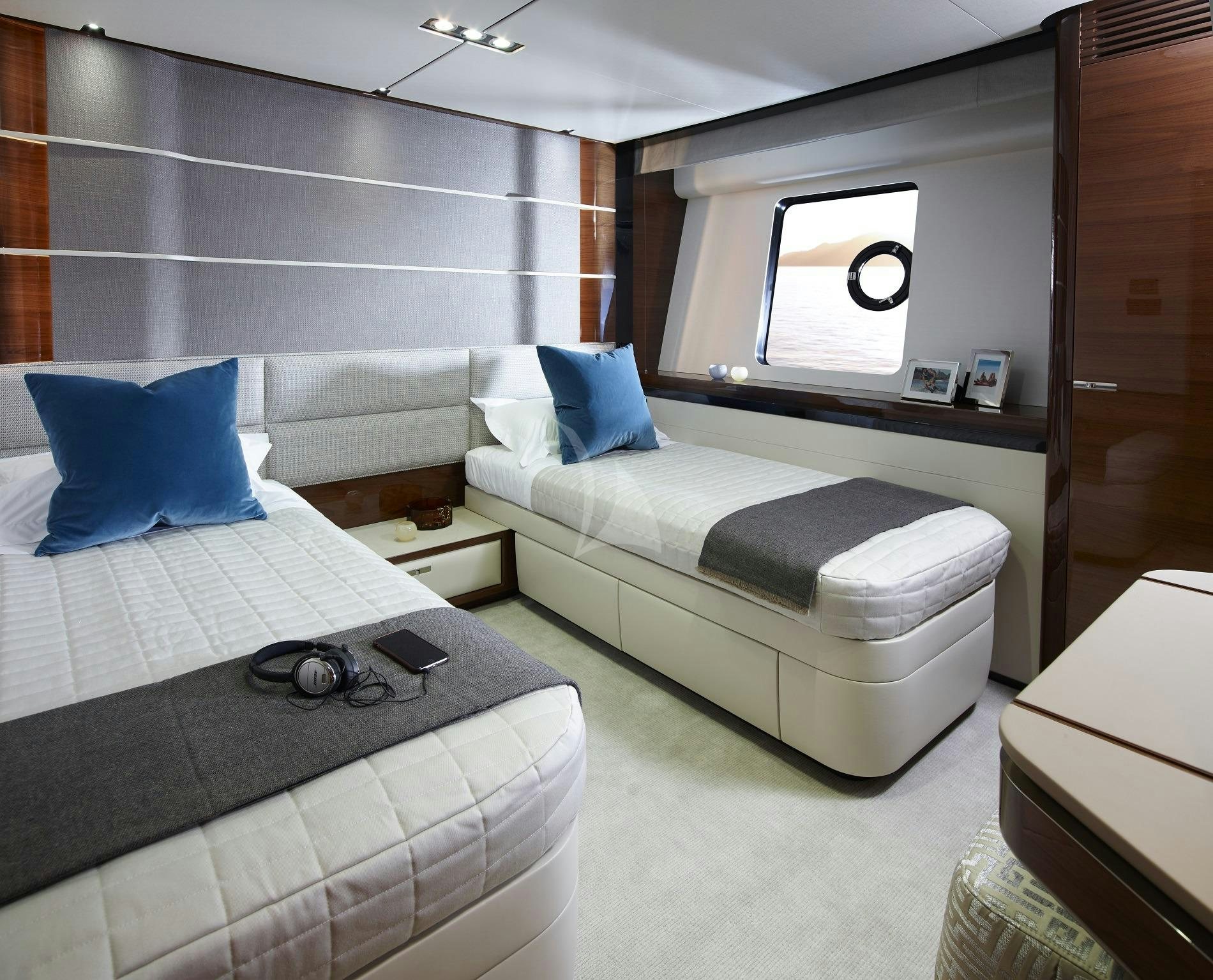 a room with a bed and a couch aboard KOHUBA Yacht for Charter