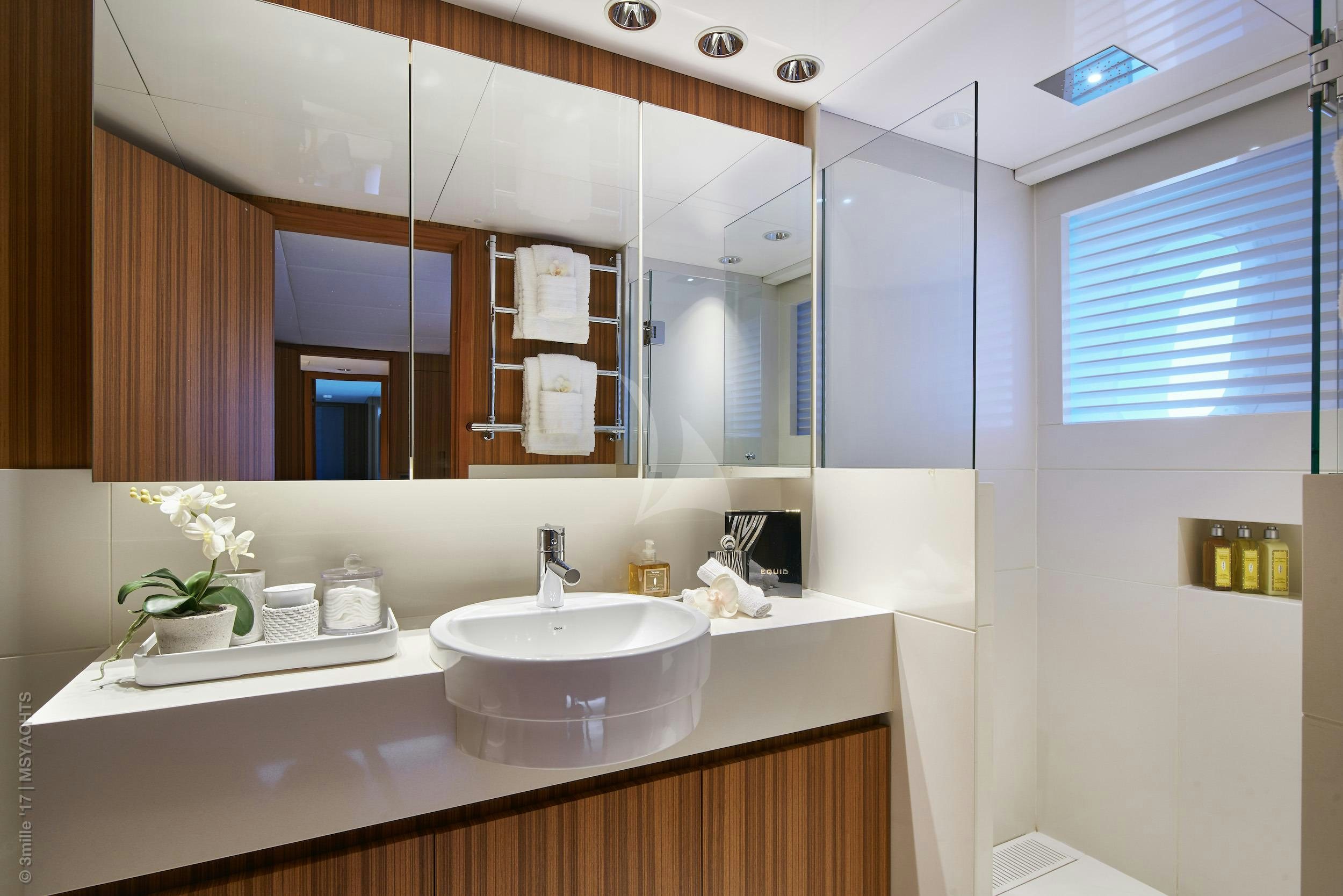 a bathroom with a large mirror aboard SEA SHELL Yacht for Charter