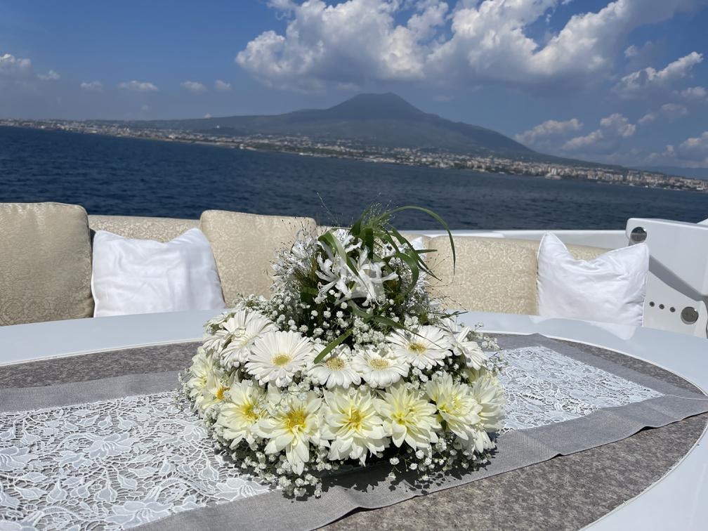 a white table with flowers on it aboard LUNASEA Yacht for Charter