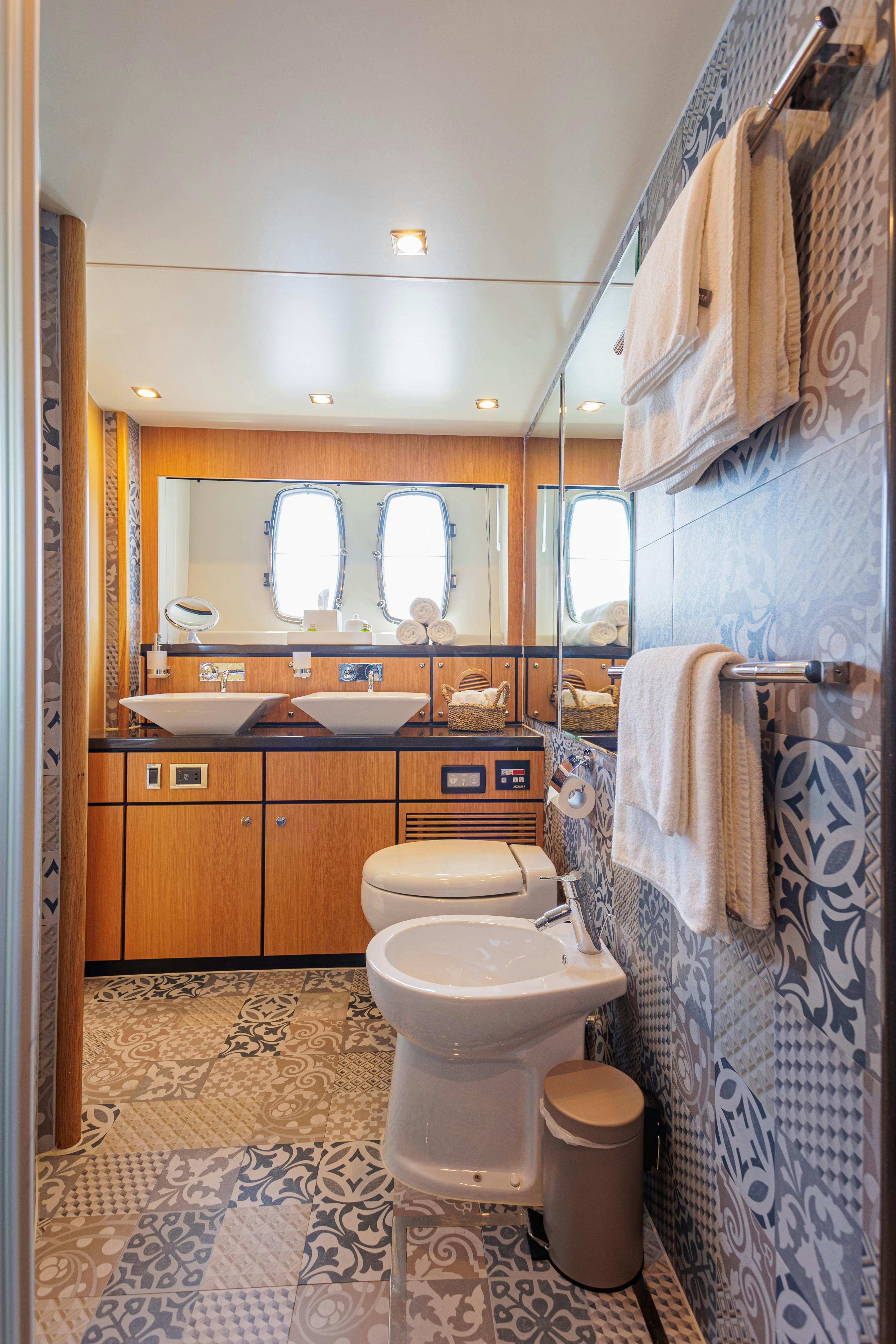 a bathroom with a toilet and sink aboard JOLIDOR Yacht for Charter