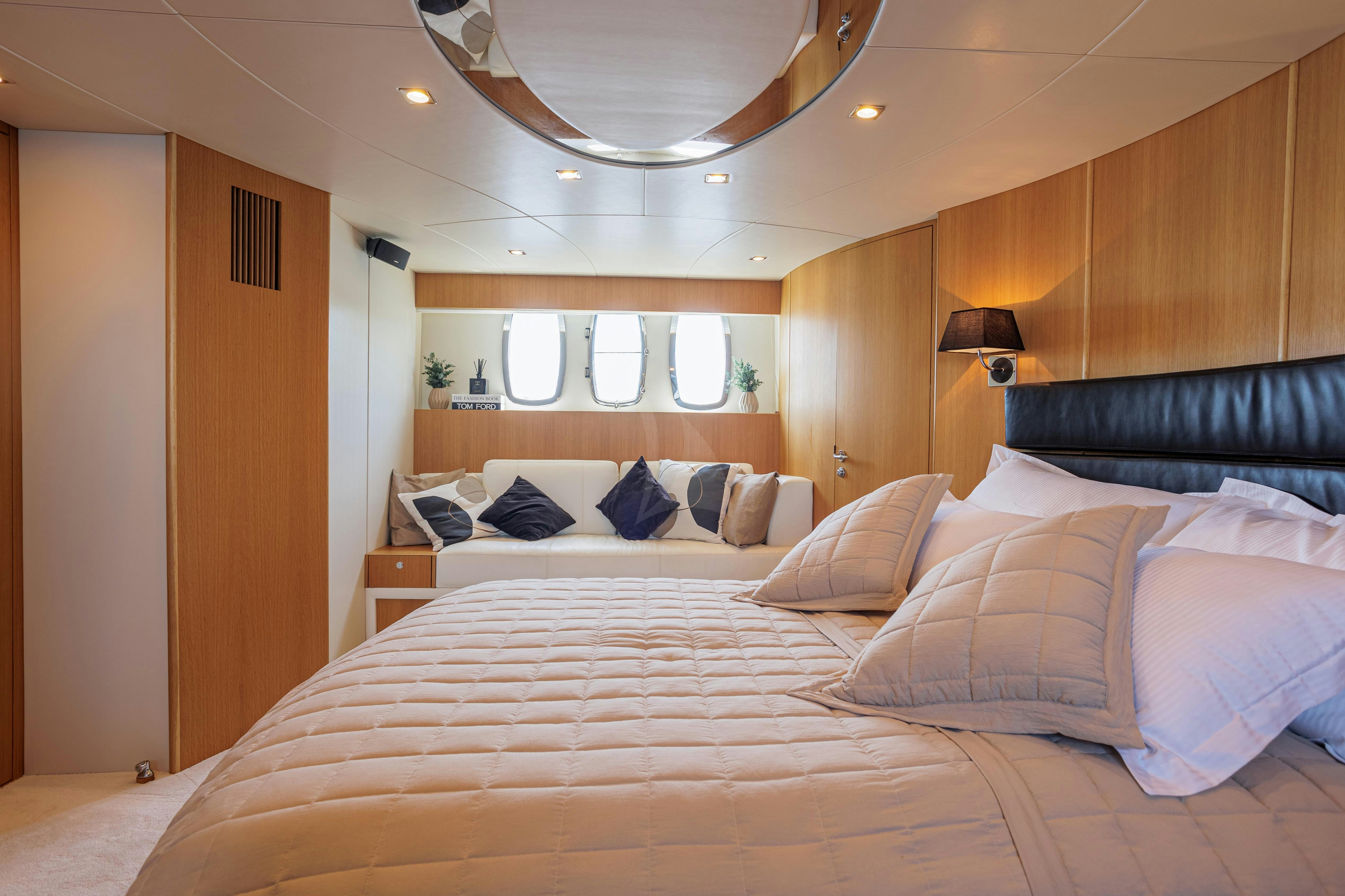 a large bed with a white bed spread aboard JOLIDOR Yacht for Charter