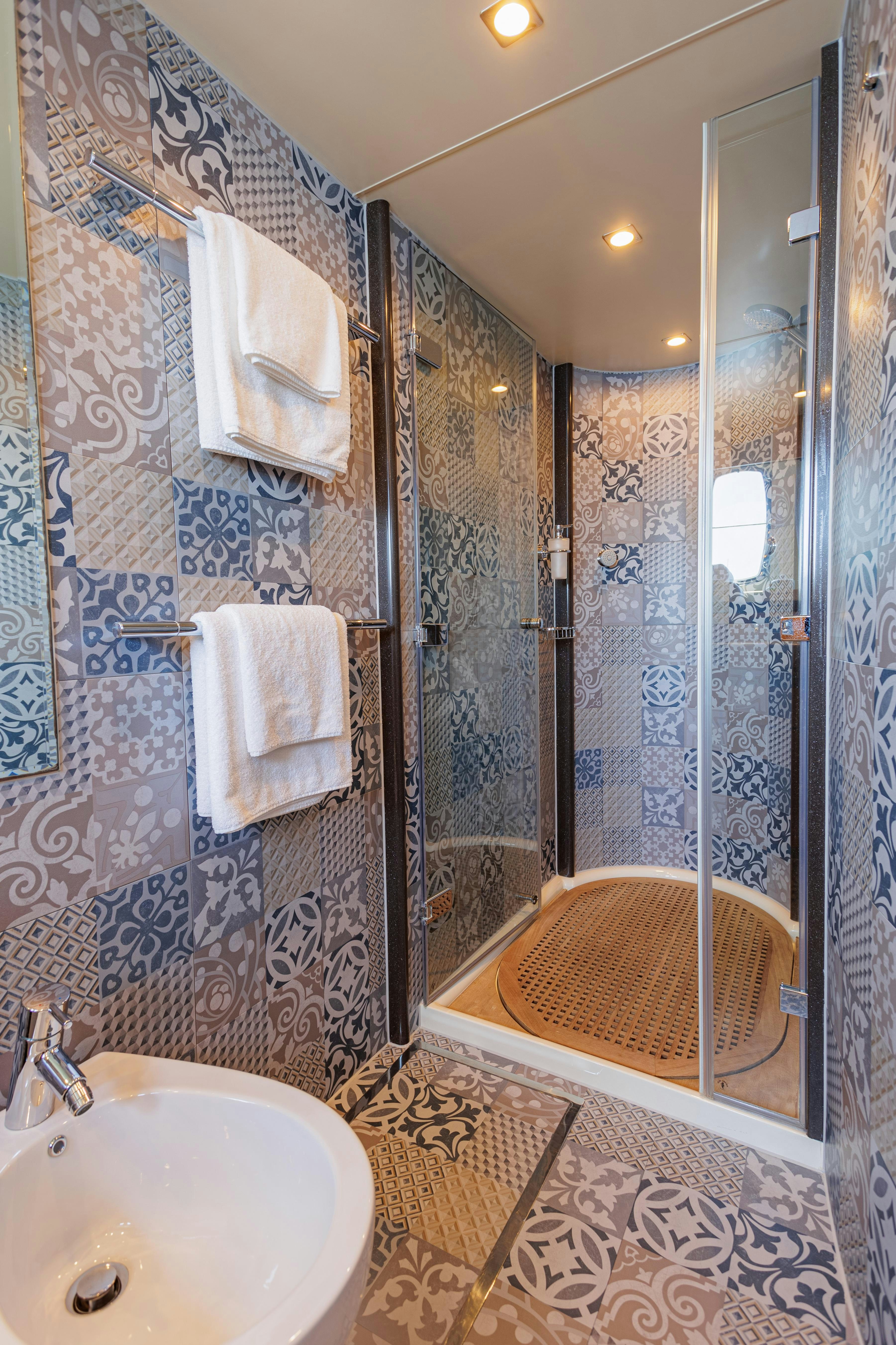 a bathroom with a sink and a shower aboard JOLIDOR Yacht for Charter