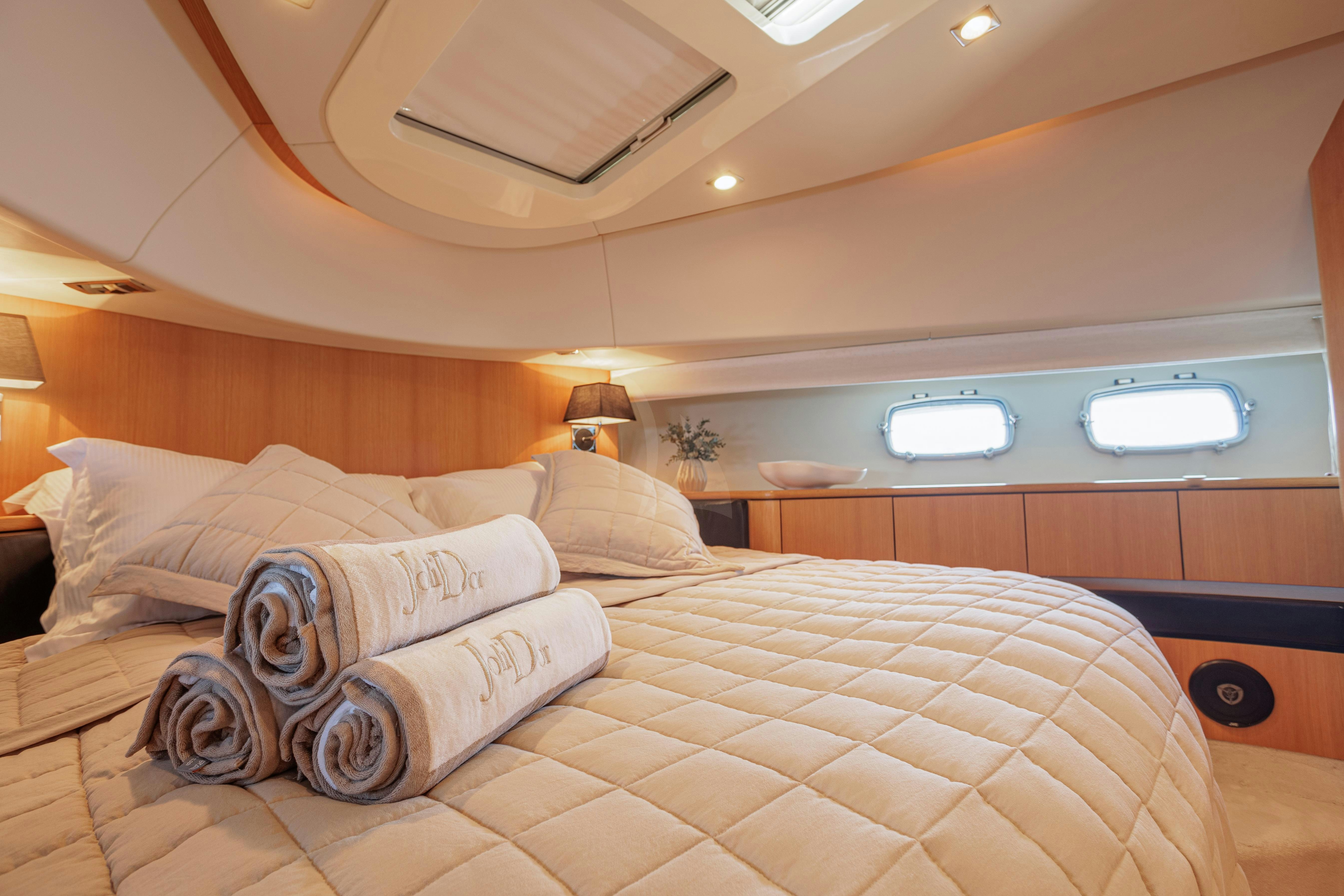 a bed with a large bed aboard JOLIDOR Yacht for Charter