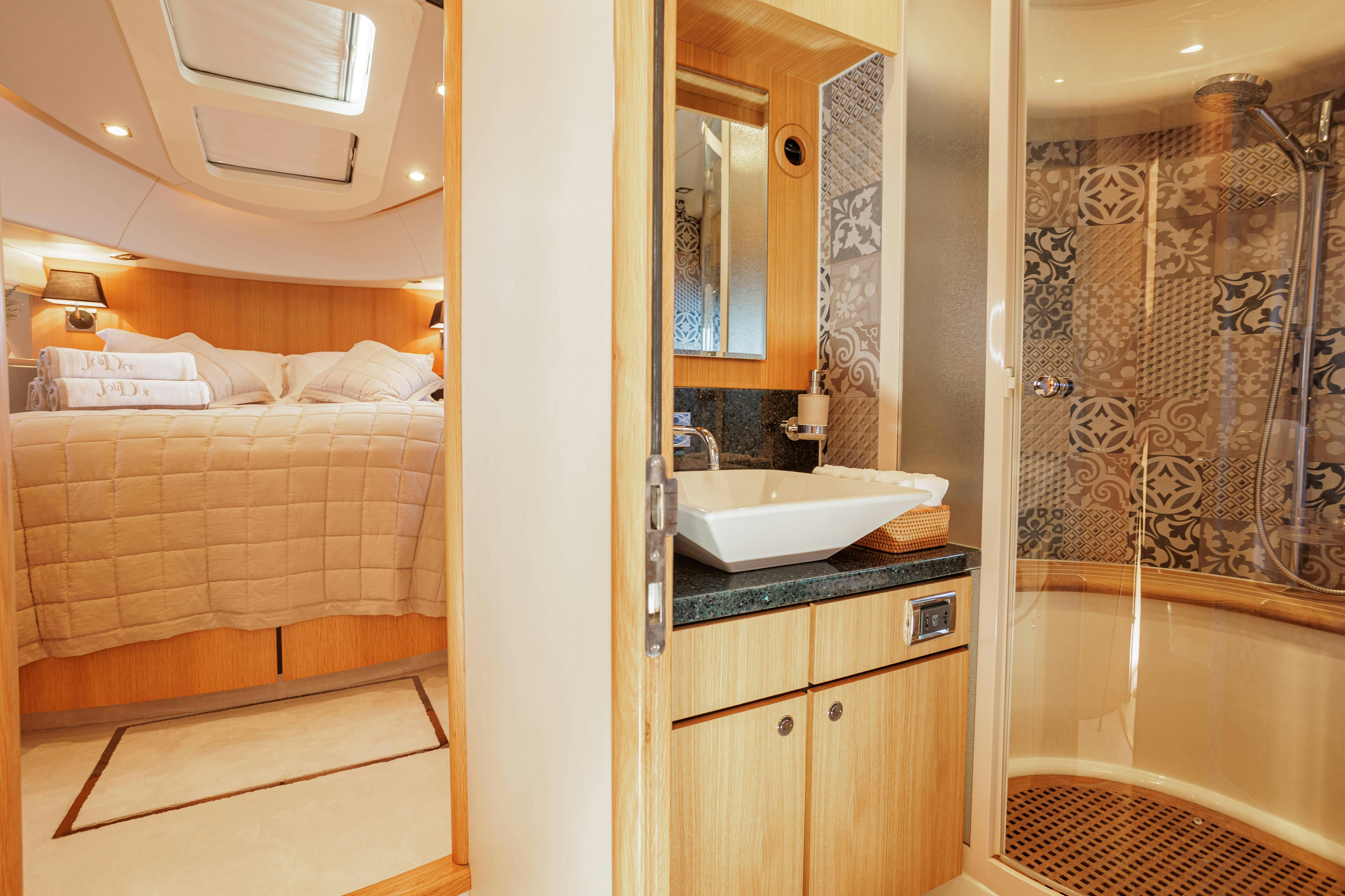 a bathroom with a sink and a bathtub aboard JOLIDOR Yacht for Charter