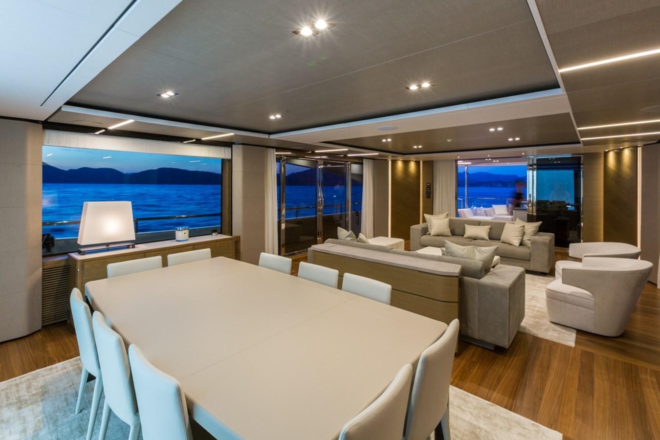 a room with a table chairs and a large screen aboard MINOR FAMILY AFFAIR Yacht for Charter