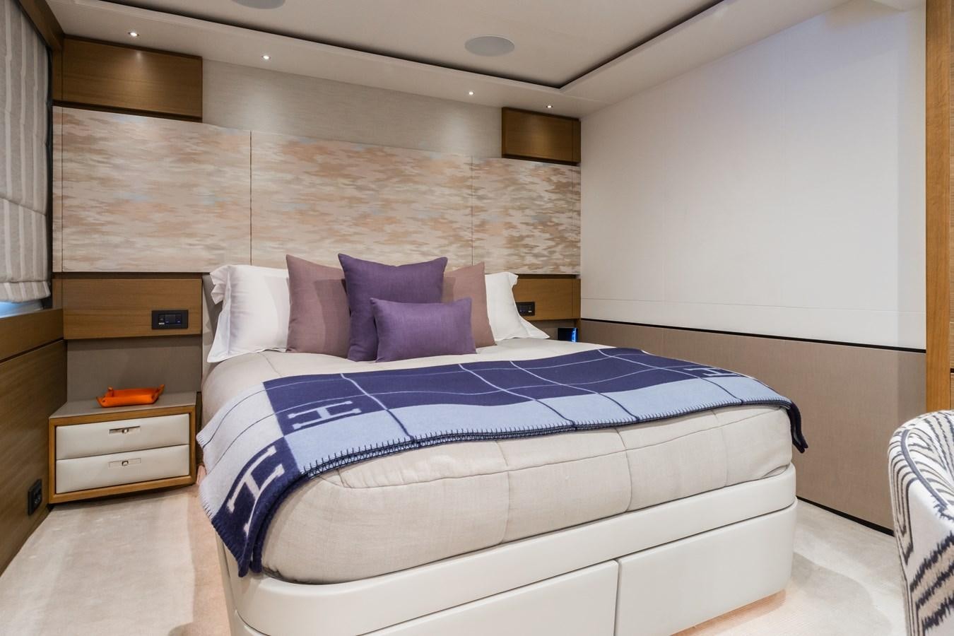 a bed with a blue and white comforter aboard MINOR FAMILY AFFAIR Yacht for Charter