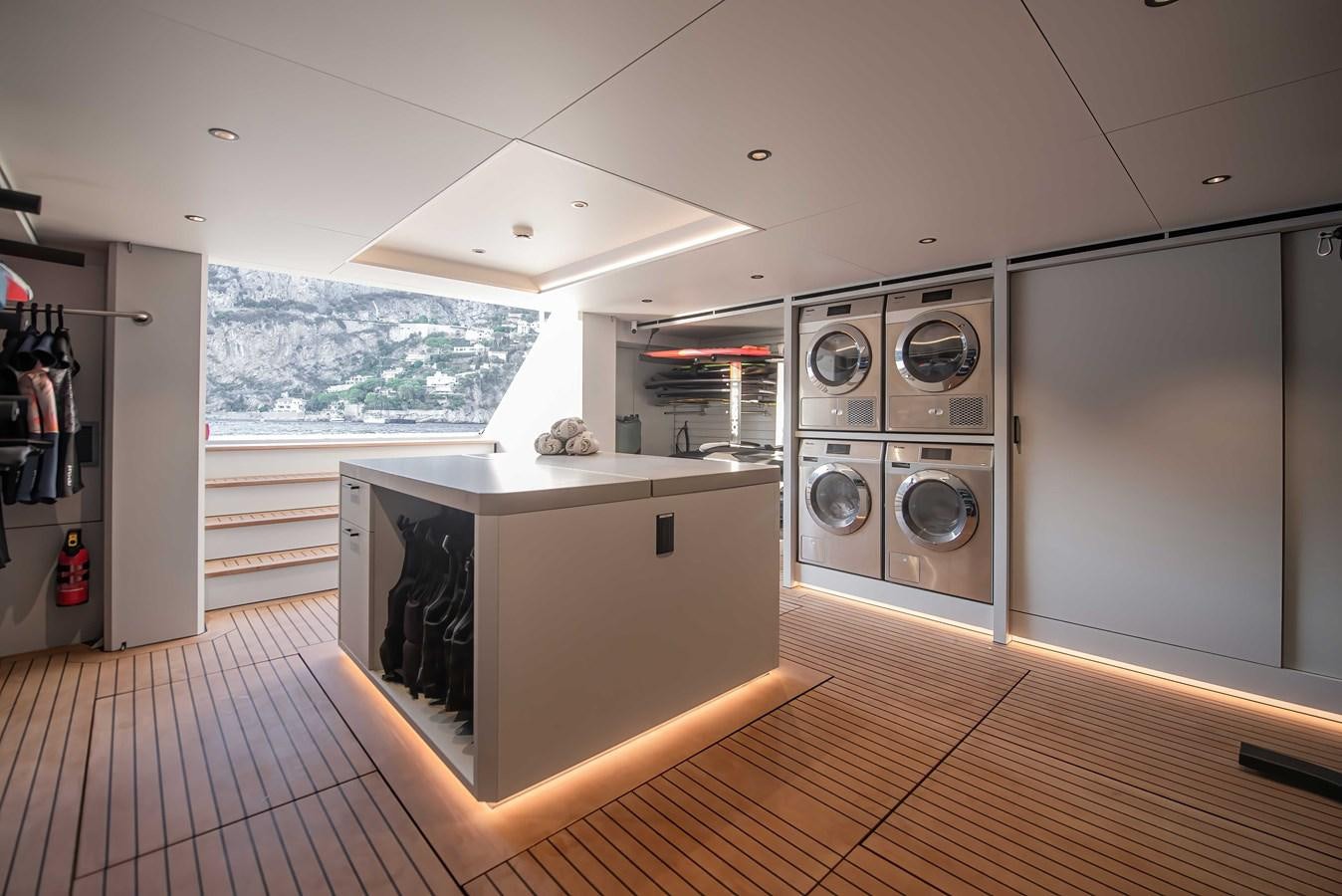a large kitchen with a large window aboard CROSSOVER 27M Yacht for Sale