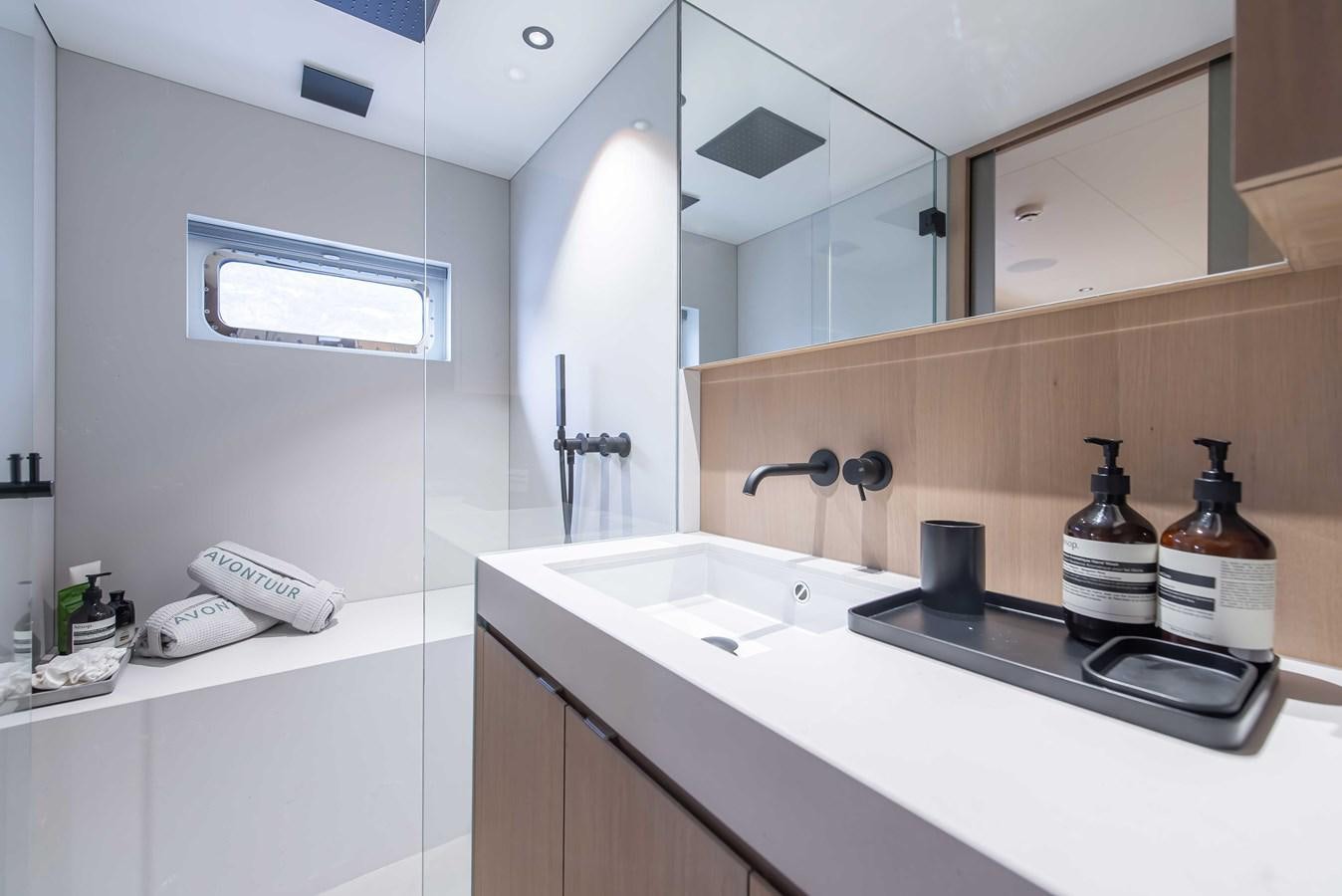 a bathroom with a sink and a mirror aboard CROSSOVER 27M Yacht for Sale