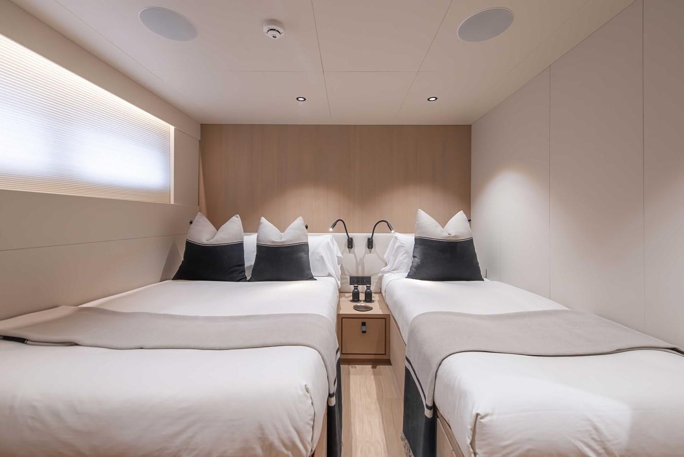 a room with two beds aboard CROSSOVER 27M Yacht for Sale