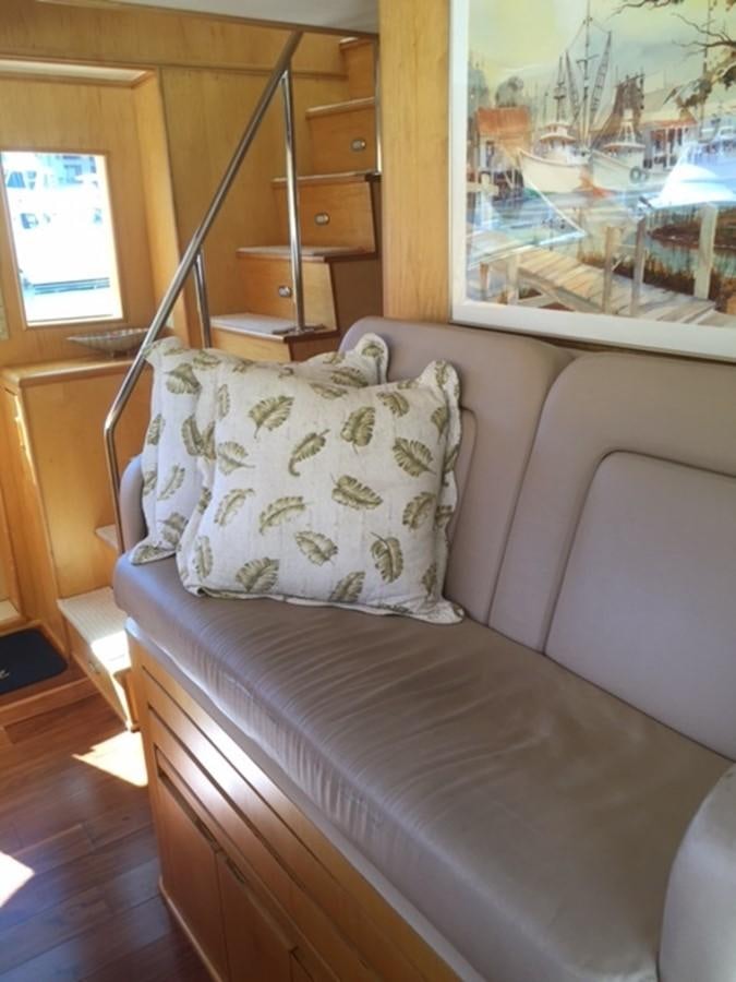 a bed with a pillow and a window aboard WHALE'S WAY Yacht for Sale