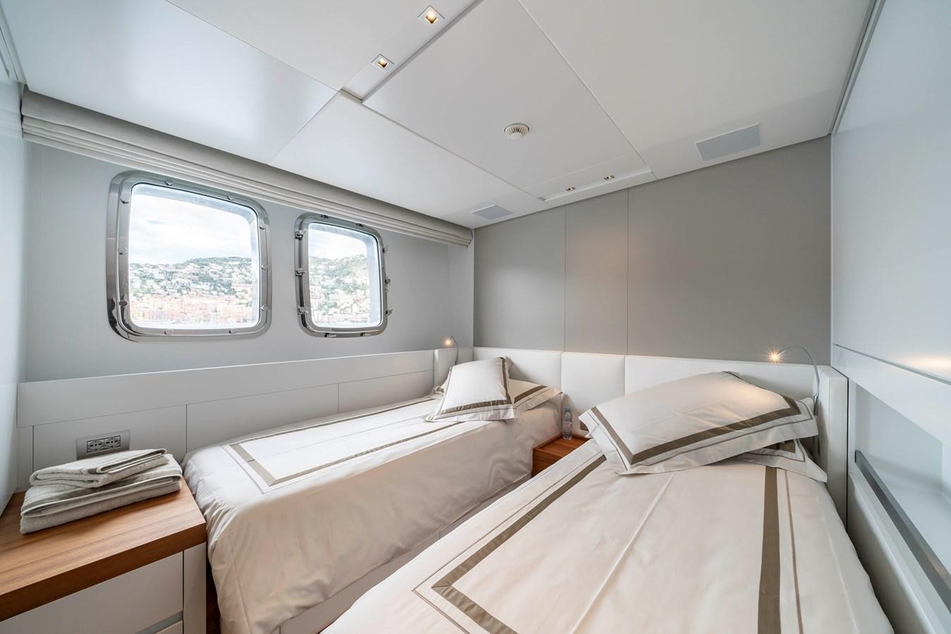a room with two beds aboard SALT Yacht for Charter