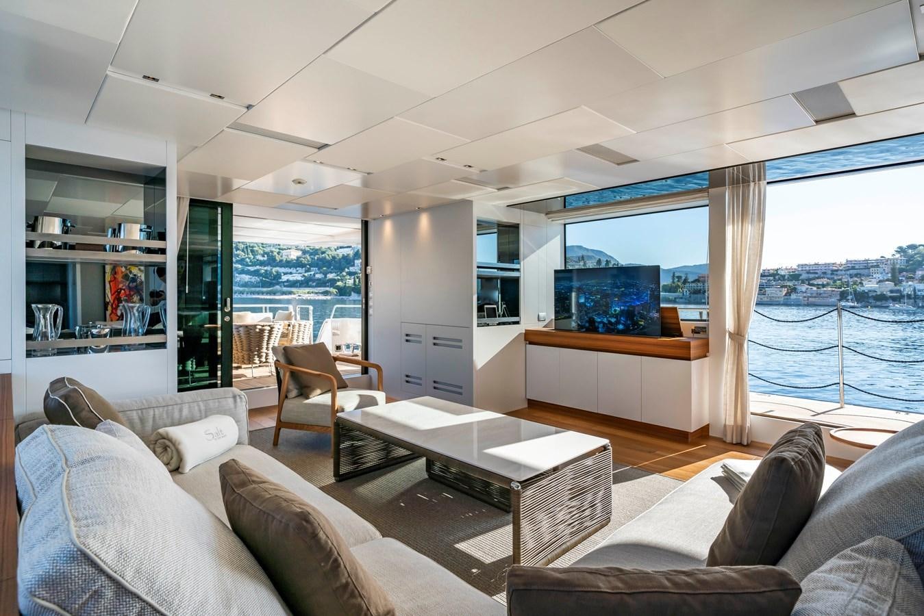 a living room with a large window aboard SALT Yacht for Charter