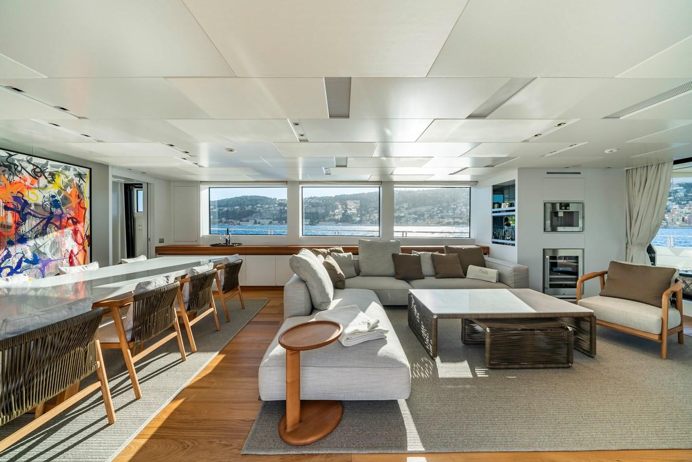 a living room with a large screen aboard SALT Yacht for Charter