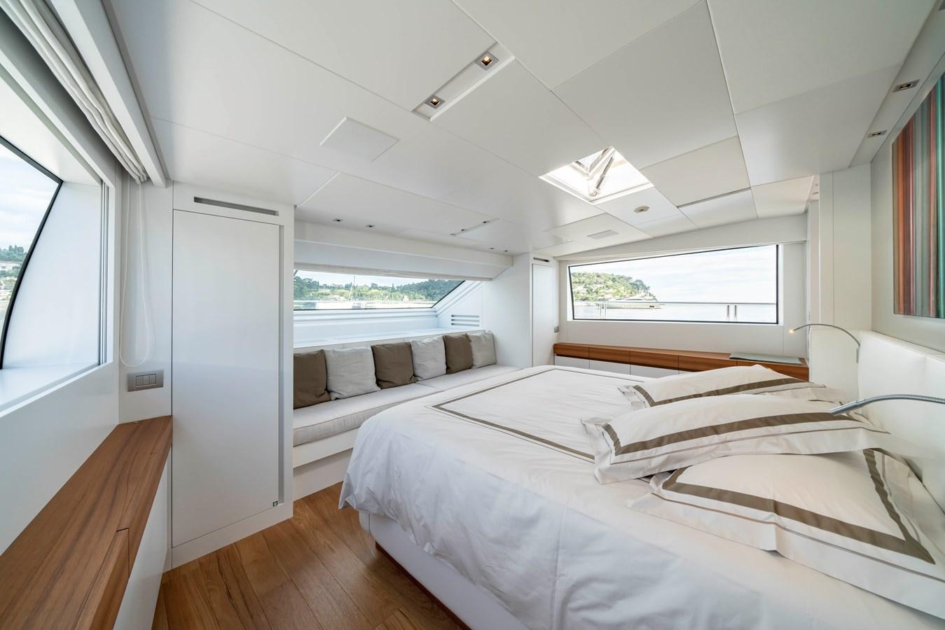 a room with a group of beds aboard SALT Yacht for Charter