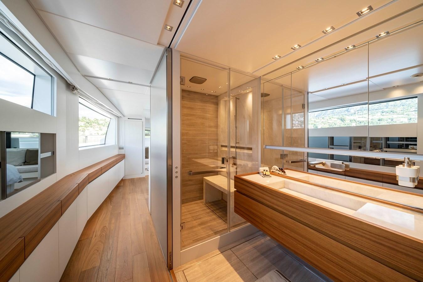 a room with a wood floor and a large window aboard SALT Yacht for Charter