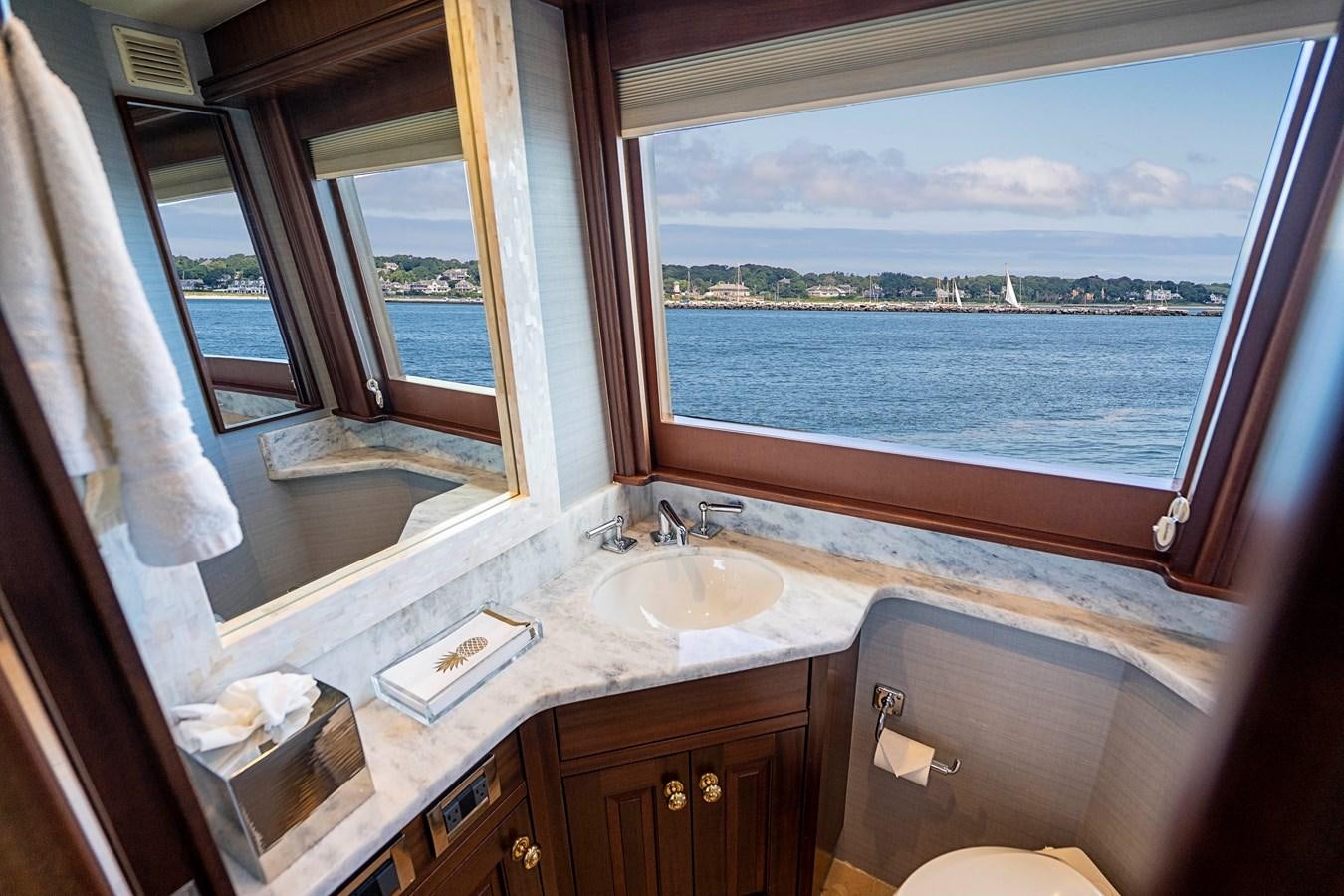 a bathroom with a sink and a window aboard TRANQUILITY Yacht for Charter