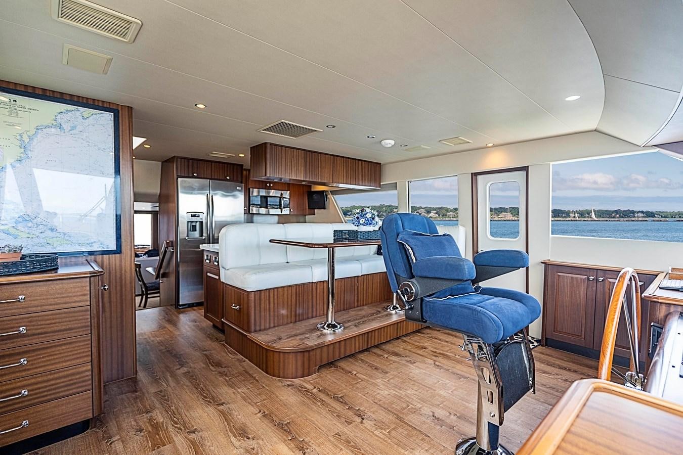 a room with a table chairs and a tv aboard TRANQUILITY Yacht for Charter