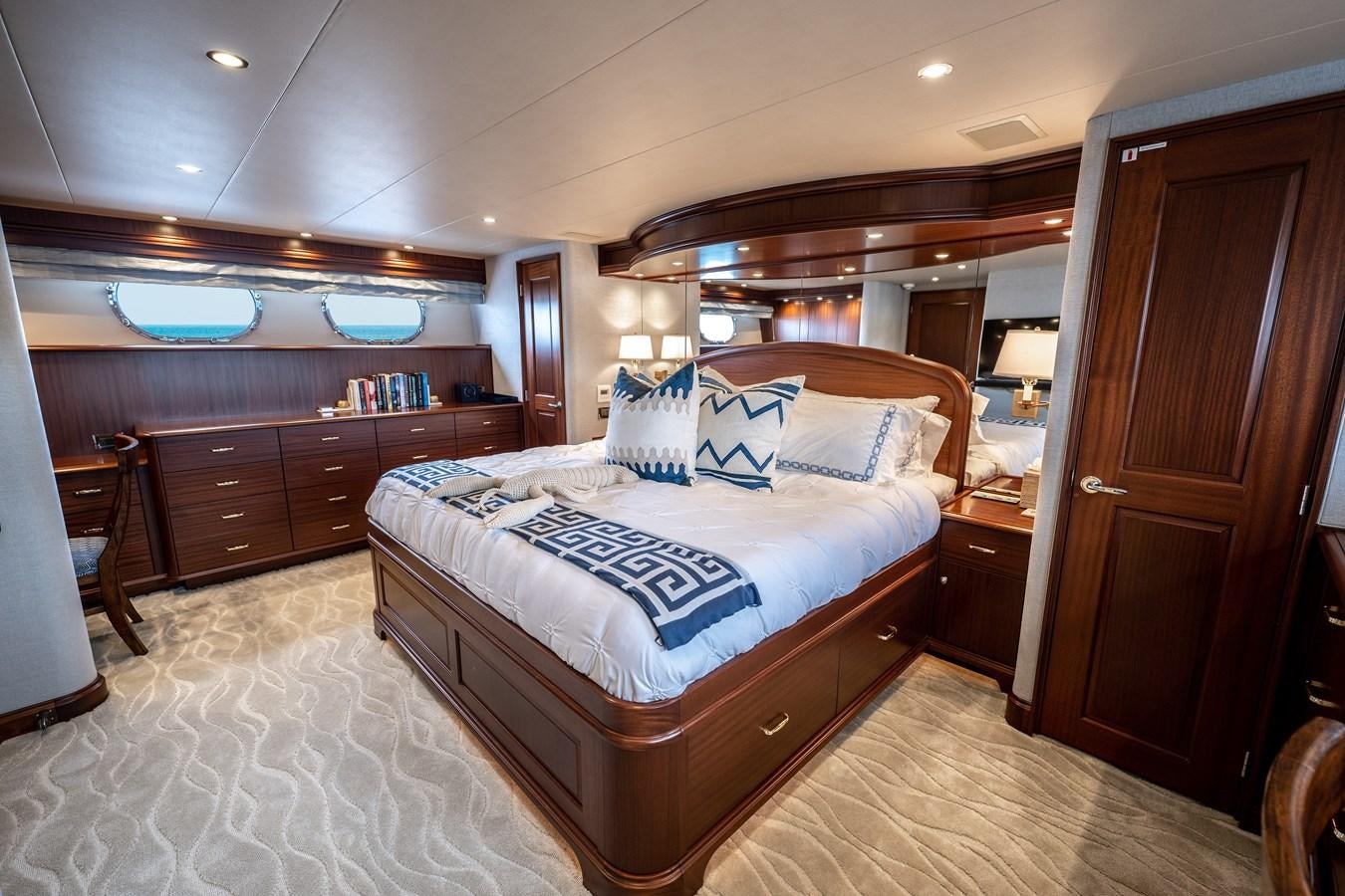 a bedroom with a bed and a desk aboard TRANQUILITY Yacht for Charter